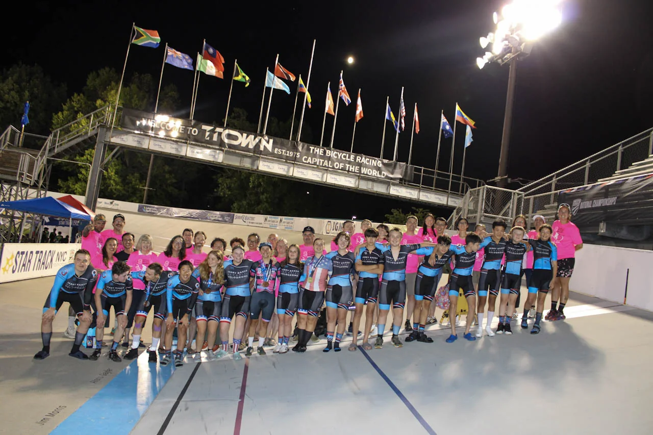 Jerry Baker Juniors riders and coaches together on the velodrome after racing at night